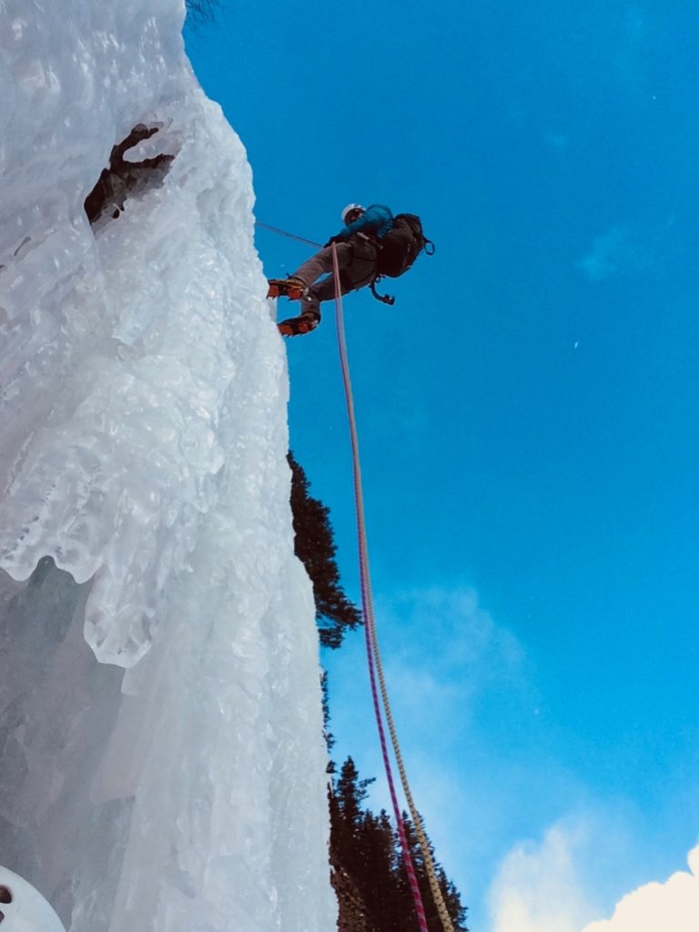 Rappelling over the steep crux ice pitch on Moonlight Falls in Kananaskis