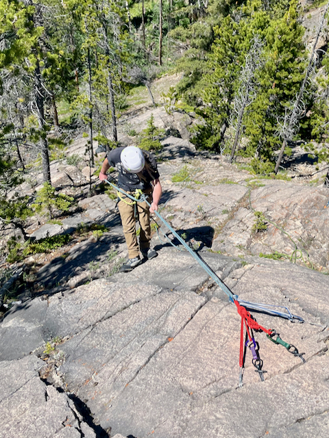 Rappelling from trad gear on a ropework and rescue course